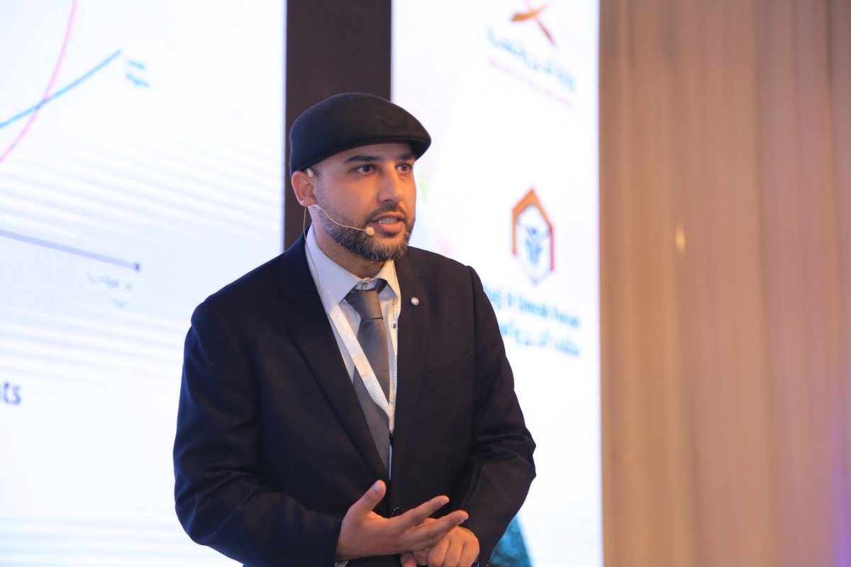 Mohsin Tutla speaking with a headset microphone at the Hajj and Umrah Forum