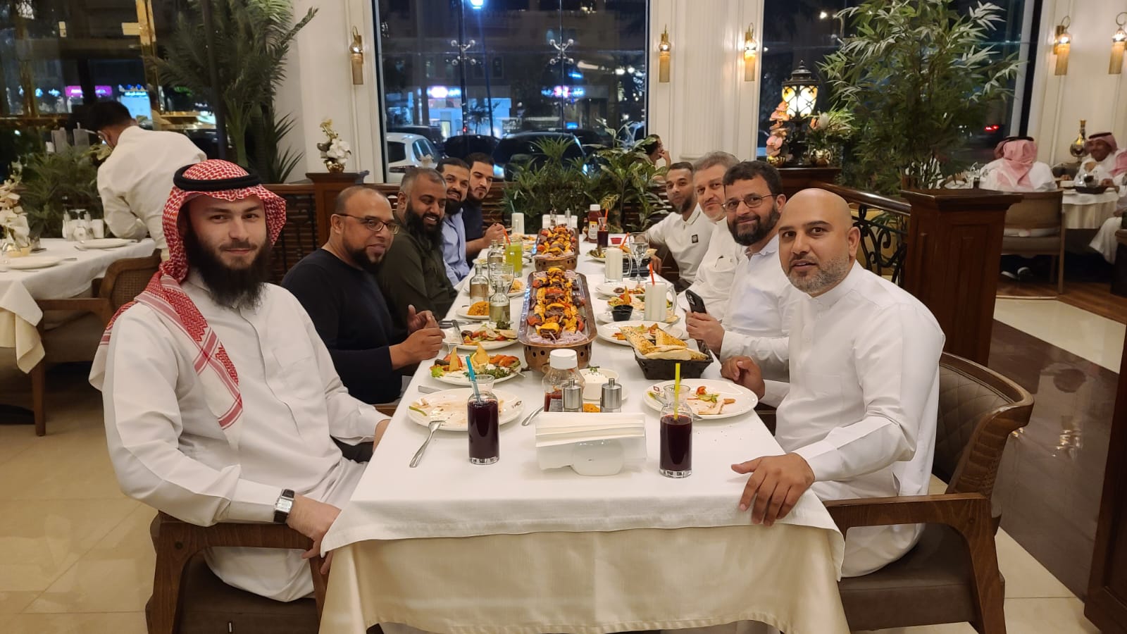 Mohsin Tutla at a long dinner table with colleagues