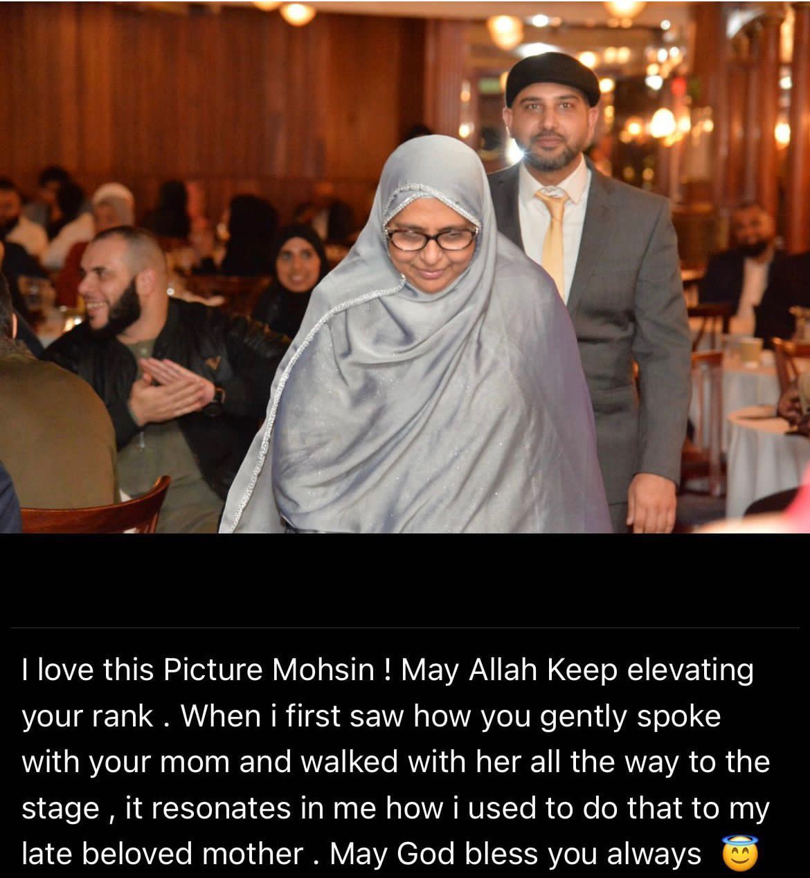 Mohsin Tutla walking beside his mother at an evening event
